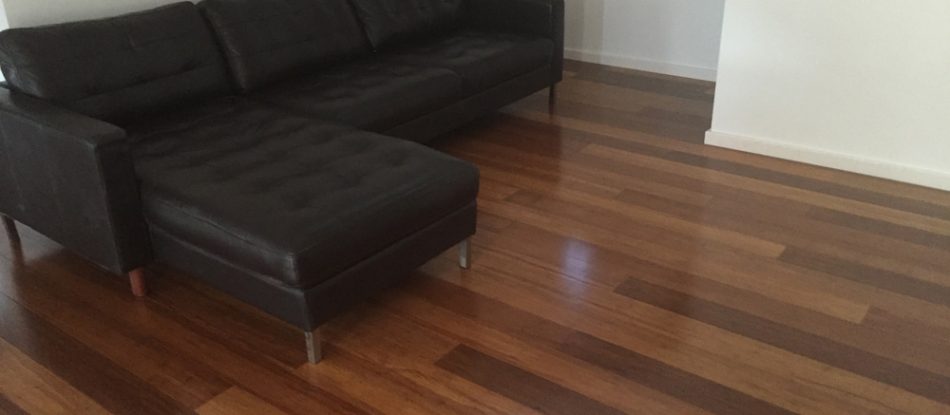 Floor Side View With Black Sofa — Timber Floors In Central Coast, NSW