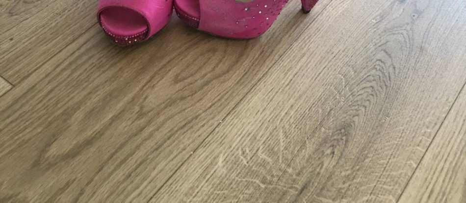 Natural Oak Laminate Flooring With Pink Shoes — Timber Floors In Central Coast, NSW